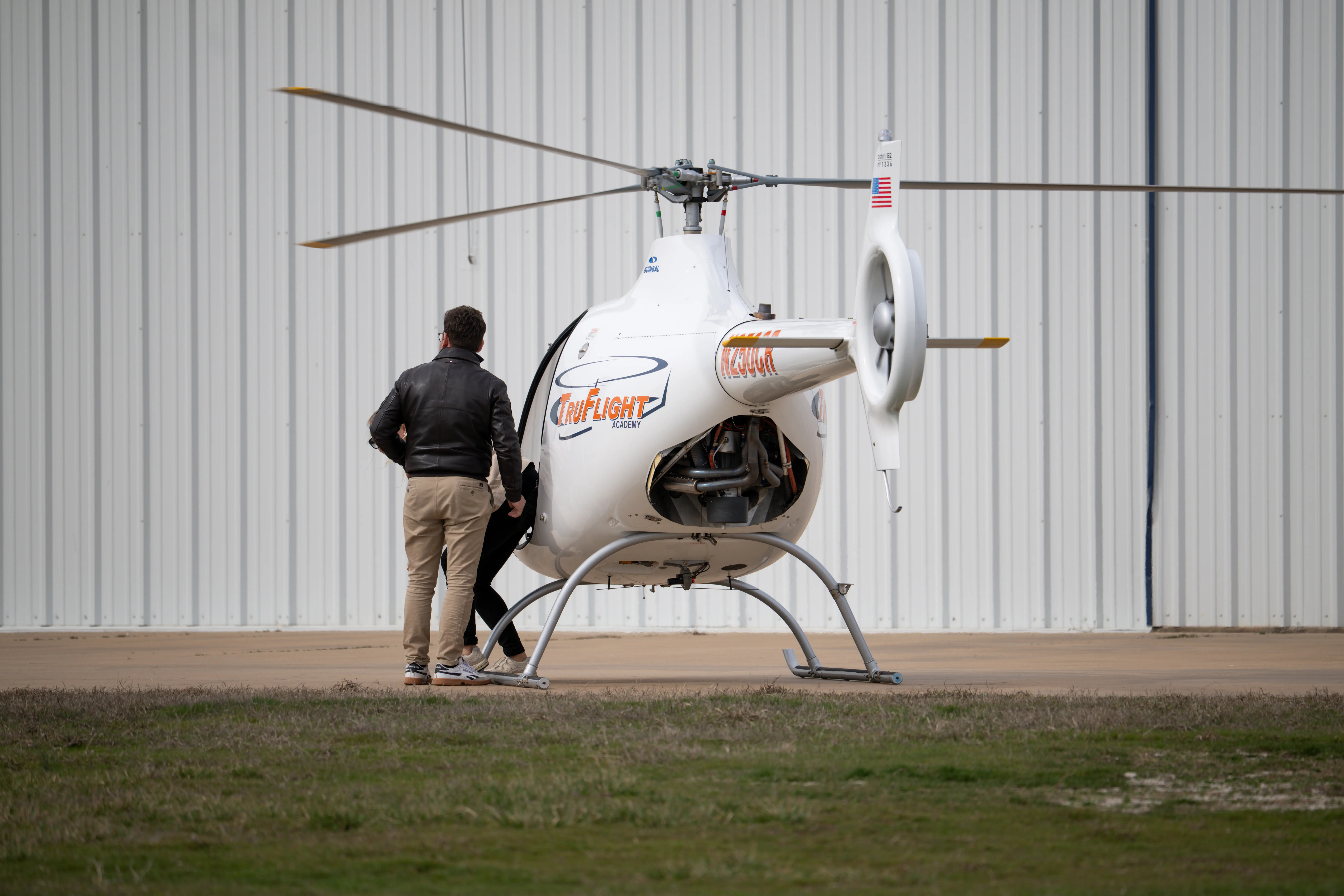 Helicopter parked in front of a hangar at TruFix Maintenance